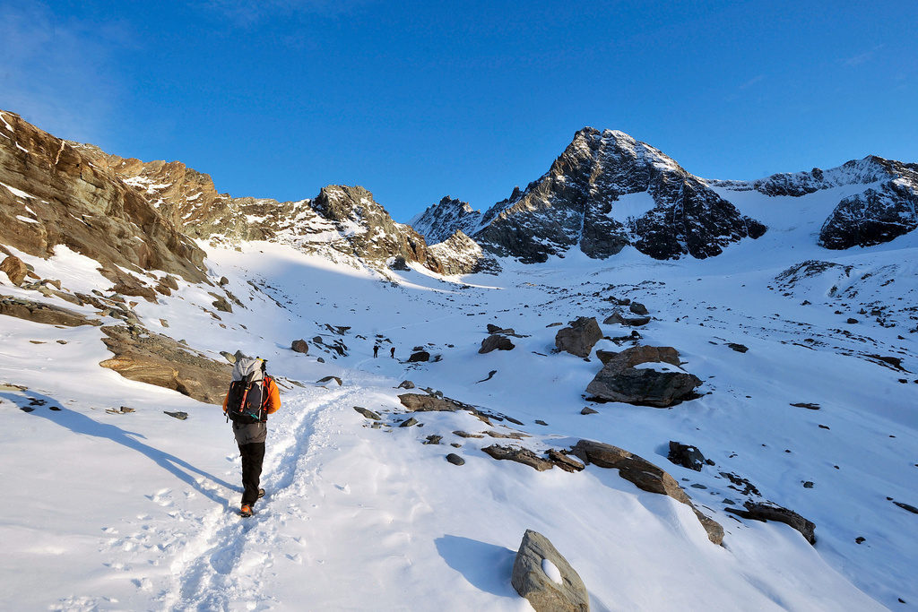 FILE - An alpinist is seen on his way to the cross on the summit of the 'Gross Glockner' mountain, right, on Austrian province of Easttyrol, on Wednesday, Oct. 8, 2008. (AP Photo/Kerstin Joensson, File)