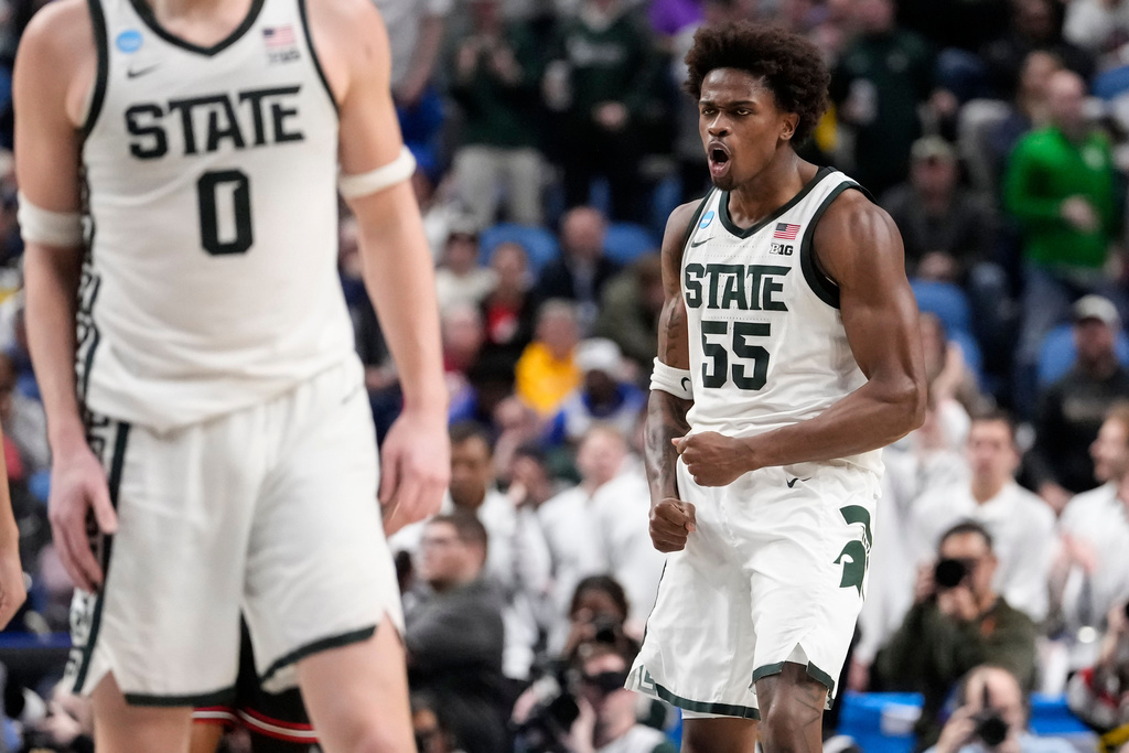 Michigan State forward Coen Carr (55) reacts after dunking against Louisville during the second half in the second round of the NCAA college basketball tournament, Saturday, March 21, 2026, in Buffalo, N.Y. (AP Photo/Yuki Iwamura)