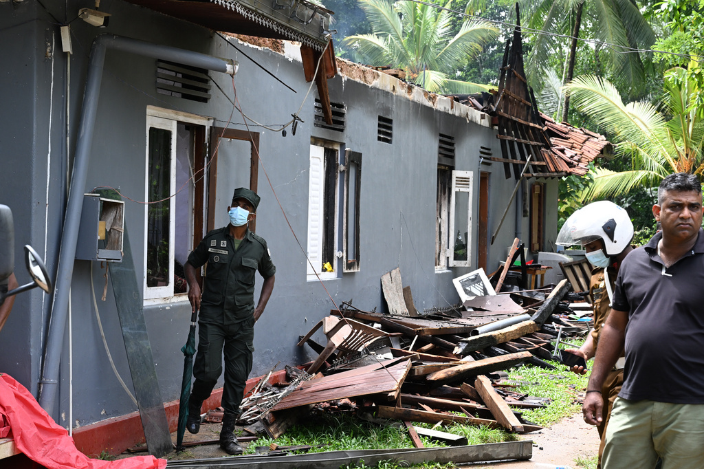 Sri Lankan army soldiers stand outside looking at the debris of a charred elderly care home in Anguruwatota, Sri Lanka, Thursday, June 4, 2026. (AP Photo)
