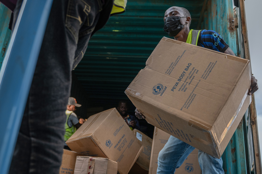 People offload a shipment of more than 15 tons of supplies donated by UNICEF as part of the response to the Ebola virus outbreak at Bunia National Airport in Bunia, Congo, Tuesday, May 19, 2026. (AP Photo/Moses Sawasawa)