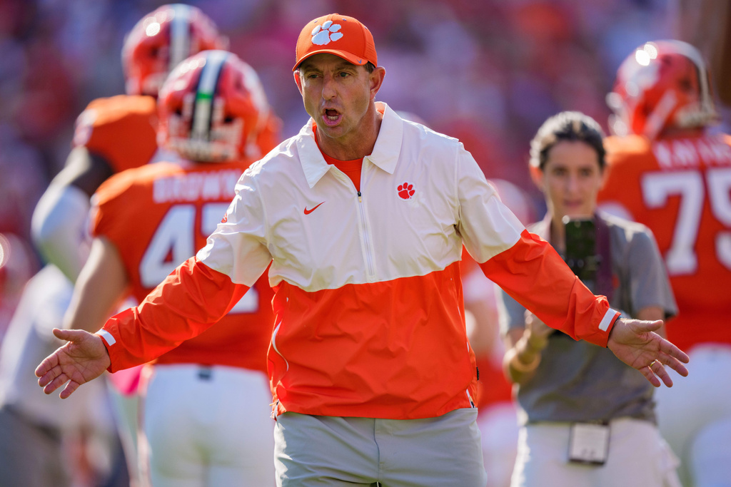 Clemson head coach Dabo Swinney greets players as they run onto the field before an NCAA college football game against SMU, Saturday, Oct. 18, 2025, in Clemson, S.C. (AP Photo/Jacob Kupferman)
