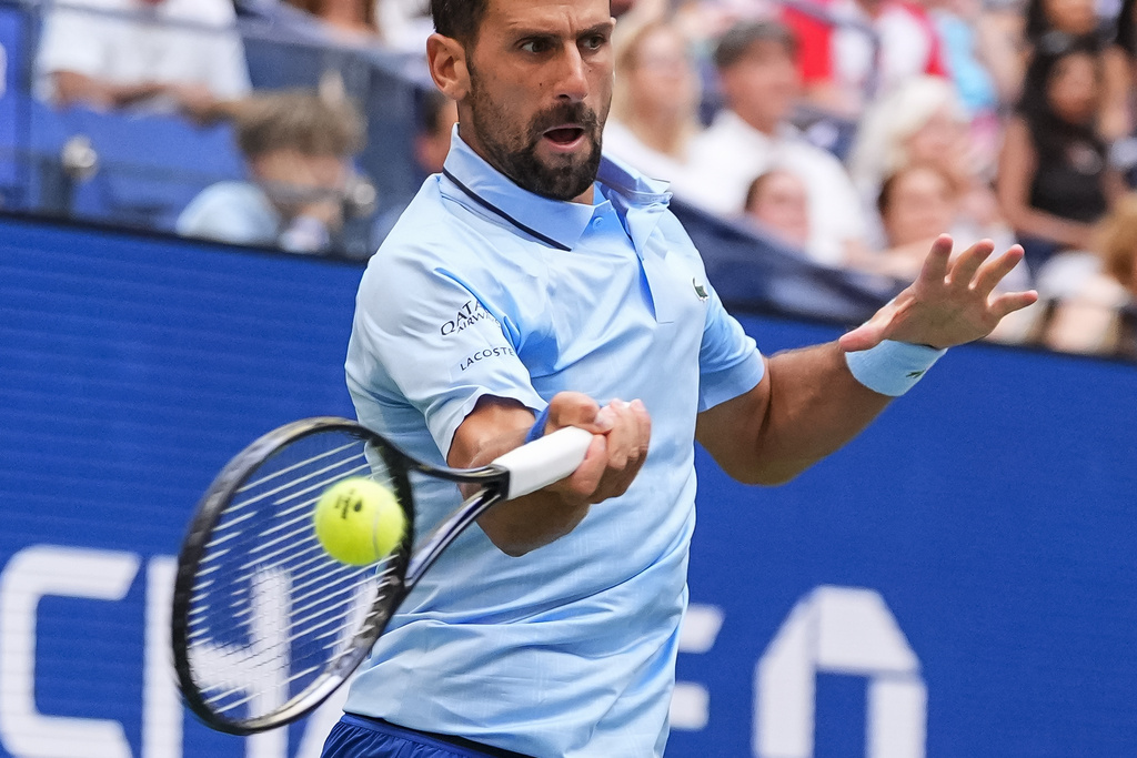 Novak Djokovic, of Serbia, returns a shot during a mixed doubles match at the U.S. Open tennis championships, Tuesday, Aug. 19, 2025, in New York. (AP Photo/Yuki Iwamura)