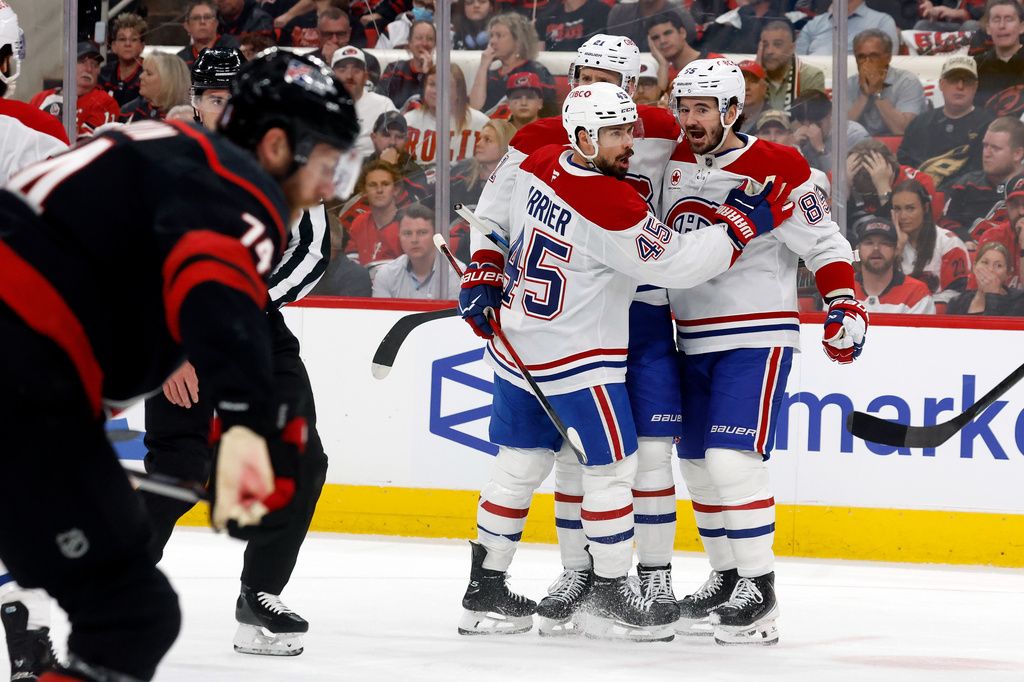 Montréal Canadiens celebrate their third goal during the first period in Game 1 of the Eastern Conference finals NHL hockey Stanley Cup playoffs series against the Carolina Hurricanes in Raleigh, N.C., Thursday, May 21, 2026. (AP Photo/Karl DeBlaker)
