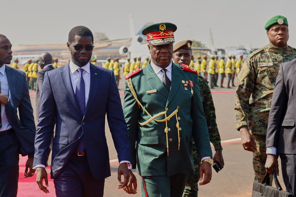 FILE - Guinea-Bissau Transitional President General Horta Inta-A-Na Man, centre, and President of Senegal Bassirou Diomaye Faye walk during an official ECOWAS mission to help resolve Guinea-Bissau's political crisis in Bissau, Guinea-Bissau, on Jan. 10, 2026. (AP Photo/Abubacar Queta, File)
