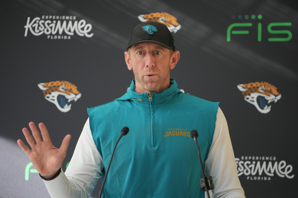 Jacksonville Jaguars head coach Liam Coen speaks to the media before an NFL football practice in Hertfordshire, England, Wednesday, Oct. 14, 2026. (AP Photo/Kin Cheung)