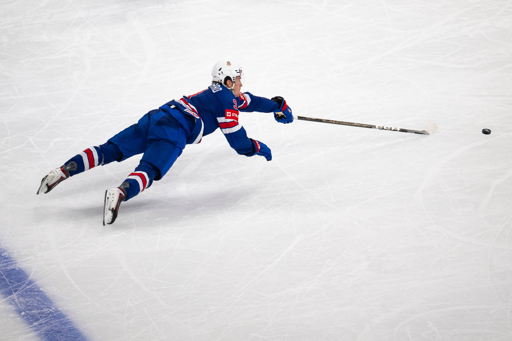 Ryan Leonard of the U.S. reaches for the puck during the 2026 IIHF Men's Ice Hockey World Championship preliminary round group A game between United States and Hungary, in Zurich, Switzerland, Monday, May 25, 2026. (Andreas Becker/Keystone via AP)