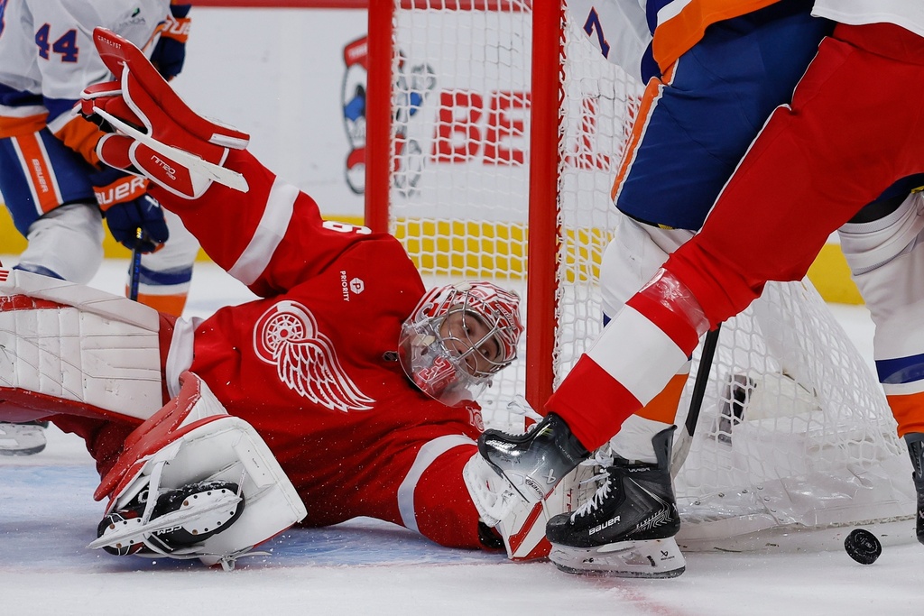 Detroit Red Wings goaltender John Gibson (36) reaches out for the puck against the New York Islanders during the first period of an NHL hockey game Tuesday, Dec. 16, 2025, in Detroit. (AP Photo/Duane Burleson)