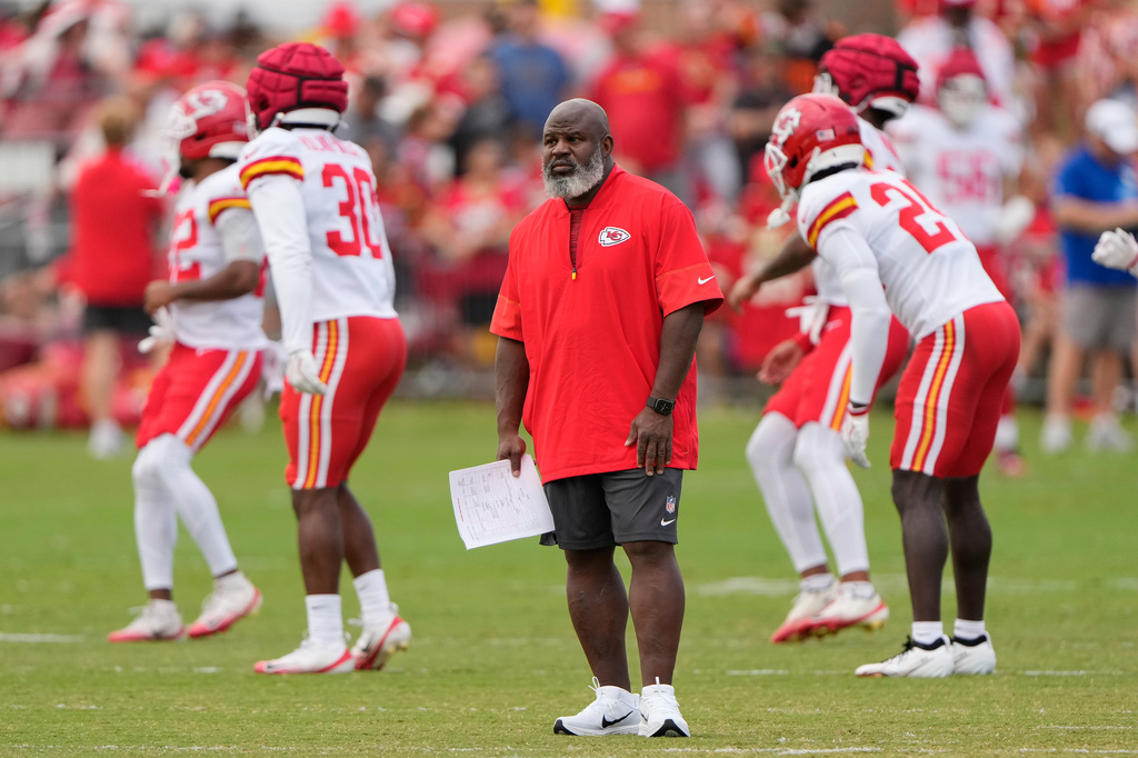 Kansas City Chiefs offensive coordinator Eric Bieniemy watches NFL football training camp Tuesday, Aug. 11, 2026, in St. Joseph, Mo. (AP Photo/Charlie Riedel)