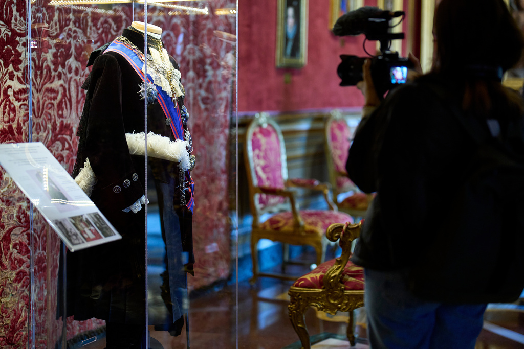 A journalist films the uniform of the Assistant at the Pontifical Throne, worn by Prince Colonna until 1968, on display at Palazzo Colonna, or the Colonna Palace, in Rome during a media tour, Friday, Nov. 7, 2025. (AP Photo/Domenico Stinellis)