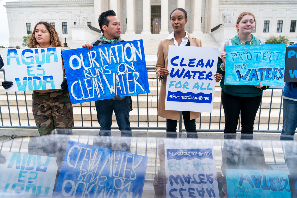 FILE - Bethsaida Sigaran, left, of Baltimore, her brother Jaime Sigaran, with American Rivers, and Thea Louis, with Clean Water Action, join other supporters of the Clean Water Act as they demonstrate outside the Supreme Court, Oct. 3, 2022, in Washington, as the court begins arguments in Sackett v. Environmental Protection Agency (EPA). (AP Photo/Jacquelyn Martin, File)