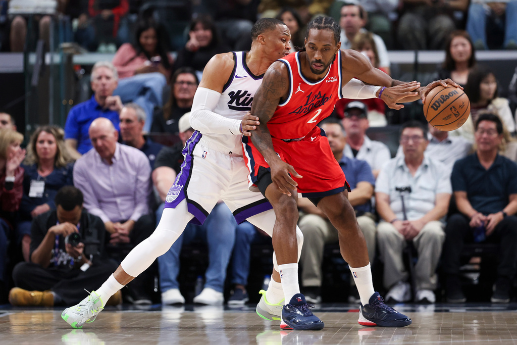 Los Angeles Clippers forward Kawhi Leonard (2) dribbles against Sacramento Kings guard Russell Westbrook, left, during the first half of an NBA basketball game, Saturday, March 14, 2026, in Inglewood, Calif. (AP Photo/Jessie Alcheh)