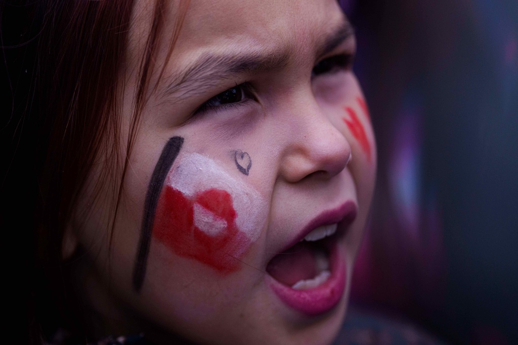 A girl shouts during protest against Trump's policy towards Greenland in front of US consulate in Nuuk, Greenland, Saturday, Jan. 17, 2026. (AP Photo/Evgeniy Maloletka)