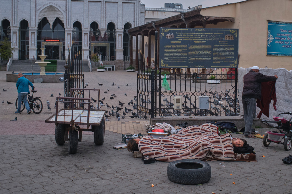 Children sleep outside of Panjshanbe Bazaar in Khujand, Tajikistan, early Sunday, May 3, 2026. (AP Photo/Jon Orbach)