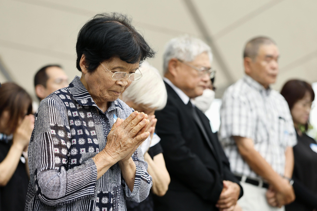 People observe a minute of silence during a ceremony to mark the 81st anniversary of the U.S. atomic bombing at the Peace Park in Nagasaki, southern Japan Sunday, Aug. 9, 2026. (Taichi Nagahisa/Kyodo News via AP)