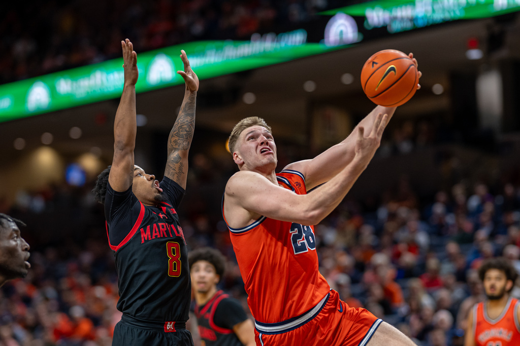 Virginia forward Thijs de Ridder (28) drives by Maryland guard David Coit (8) during the first half of an NCAA college basketball game, Saturday, Dec. 20, 2025, in Charlottesville, Va. (AP Photo/Robert Simmons)