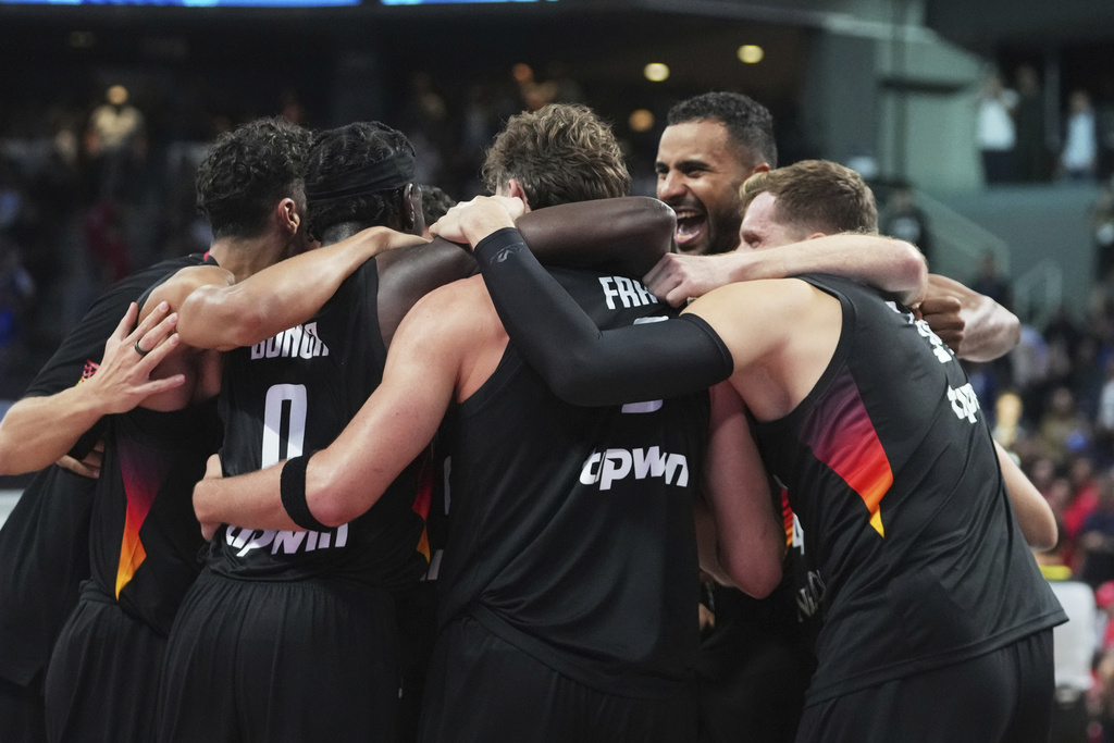 Germany players celebrate as they win the Eurobasket, European Basketball Championship final match between Turkey and Germany at the Riga Arena in Riga, Latvia, Sunday, Sept. 14, 2025. (AP Photo/Sergei Grits)