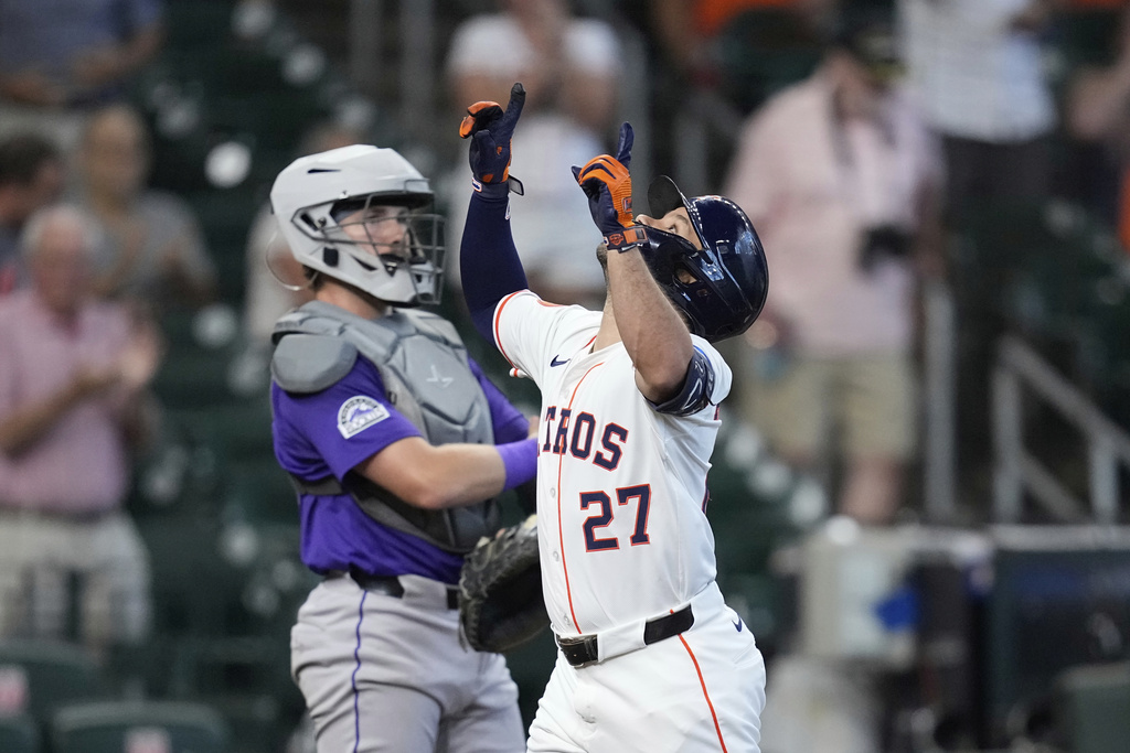 Houston Astros' Jose Altuve (27) celebrates after hitting a home run as Colorado Rockies catcher Braxton Fulford stands behind home plate during the first inning of a baseball game Thursday, Aug. 28, 2025, in Houston. (AP Photo/David J. Phillip)