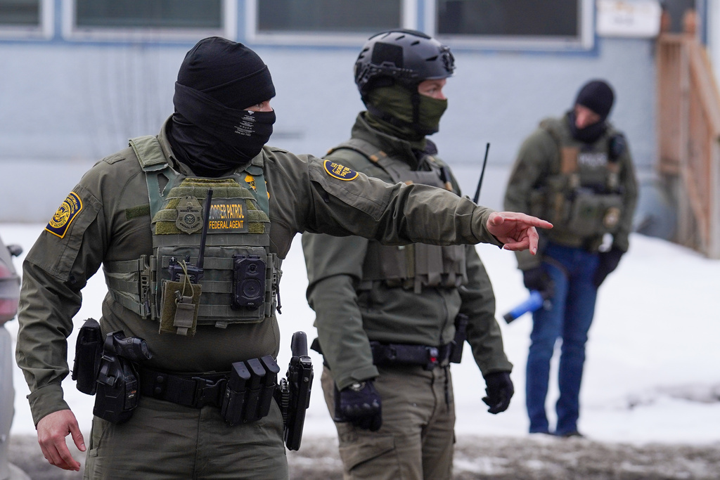 A United States Border Patrol agent gestures to a car while conducting immigration enforcement operations, Thursday, Feb. 5, 2026, in Minneapolis. (AP Photo/Ryan Murphy)