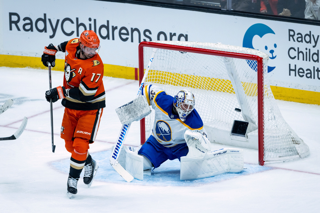 Anaheim Ducks defenseman Jackson LaCombe (not shown) scores against Buffalo Sabres goaltender Alex Lyon, right, during the first period of an NHL hockey game, Sunday, March 22, 2026, in Anaheim, Calif. (AP Photo/Ethan Swope)
