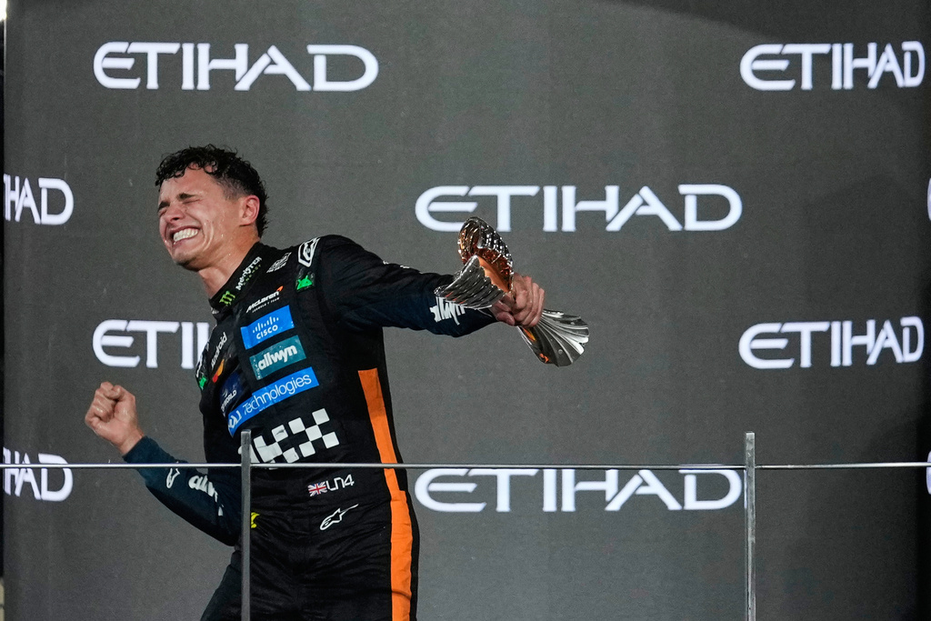McLaren driver Lando Norris of Britain celebrates after becoming a world champion after the Formula One Abu Dhabi Grand Prix at the Yas Marina Circuit in Abu Dhabi, UAE, Sunday, Dec. 7, 2025. (AP Photo/Altaf Qadri)