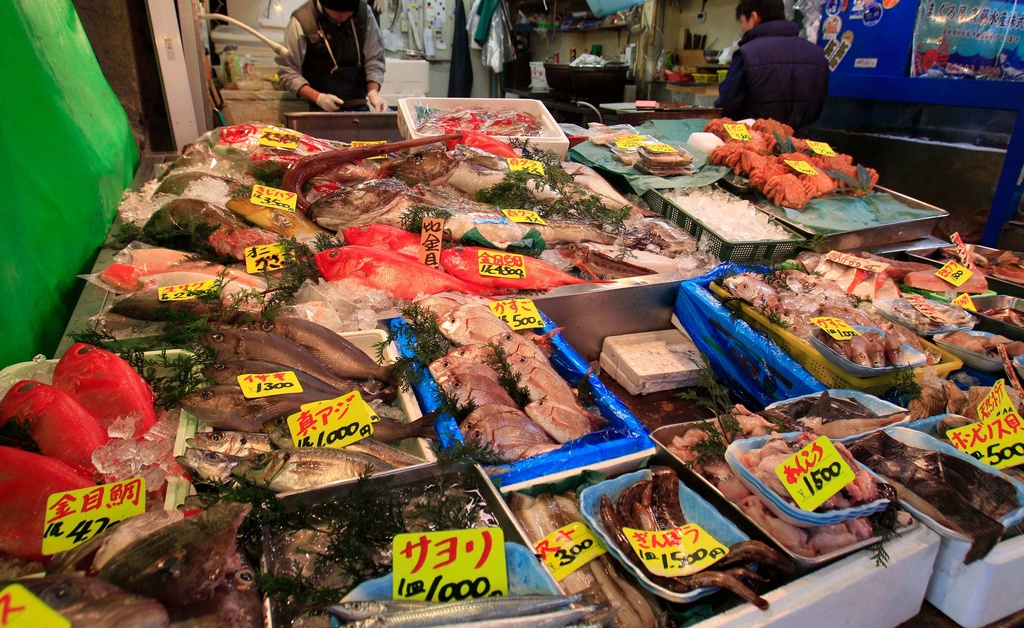 FILE - In this March 23, 2011 file photo, various types of fish are sold at a shop near the Tsukiji Fish Market, one of the world's largest fish markets, in Tokyo, after the March 11 earthquake and tsunami crippled a nuclear facility, 140 miles (220 kilometers) north of Tokyo, seeping radiation into the soil and seawater nearby. (AP Photo/Lee Jin-man, File)