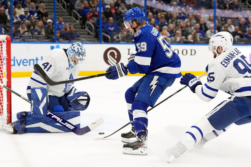 Tampa Bay Lightning center Jake Guentzel (59) gets off a shot on Toronto Maple Leafs goaltender Anthony Stolarz (41) during the second period of an NHL hockey game Wednesday, Feb. 25, 2026, in Tampa, Fla. (AP Photo/Chris O'Meara)