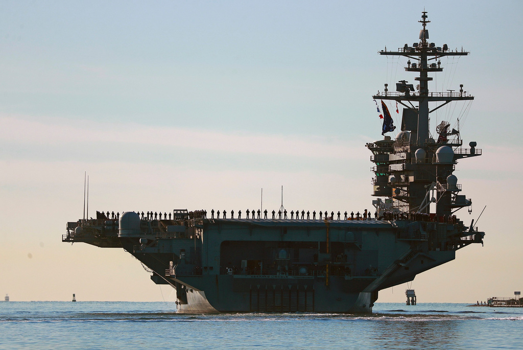 FILE - Sailors and marines line the deck of aircraft carrier USS Abraham Lincoln (CVN-72) as it deploys from San Diego,, Jan. 3, 2021. (K.C. Alfred/The San Diego Union-Tribune via AP, File)