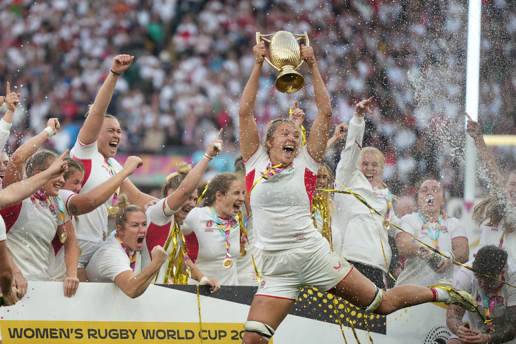 England's Zoe Aldcroft holds a trophy as she celebrates with her teammates after winning the Women's Rugby World Cup final match between England and Canada at the Allianz Stadium, Twickenham, London, Saturday, Sept. 27, 2025. (AP Photo/Alastair Grant)