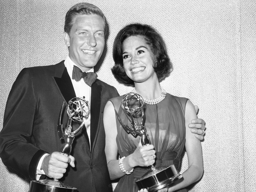 FILE - Dick Van Dyke, left, and Mary Tyler Moore, co-stars of "The Dick Van Dyke Show" backstage with their Emmys for best actor and actress in a series at the Television Academy's 16th annual awards show, in Los Angeles on May 25, 1964 (AP Photo, File)
