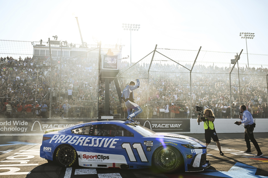 Denny Hamlin, center, celebrates after winning a NASCAR Cup Series auto race at World Wide Technology Raceway, Sunday, Sept. 7, 2025, in Madison, Ill. (AP Photo/Connor Hamilton)