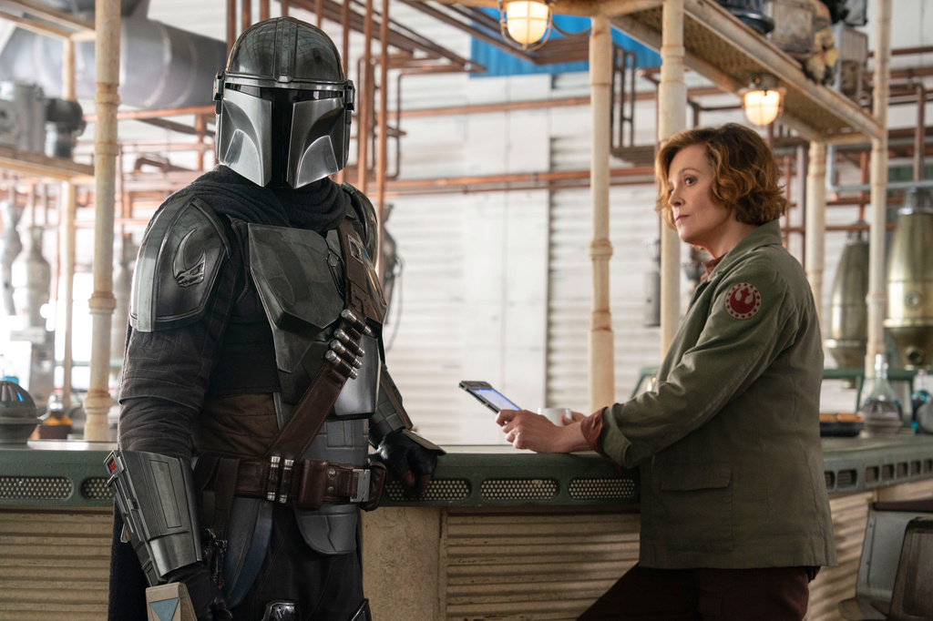 This image released by Disney shows The Mandalorian, portrayed by Pedro Pascal, left, and Colonel Ward, performed by Sigourney Weaver, in a scene from Lucasfilm's "Star Wars: The Mandalorian and Grogu." (Lucasfilm Ltd. - Disney via AP)