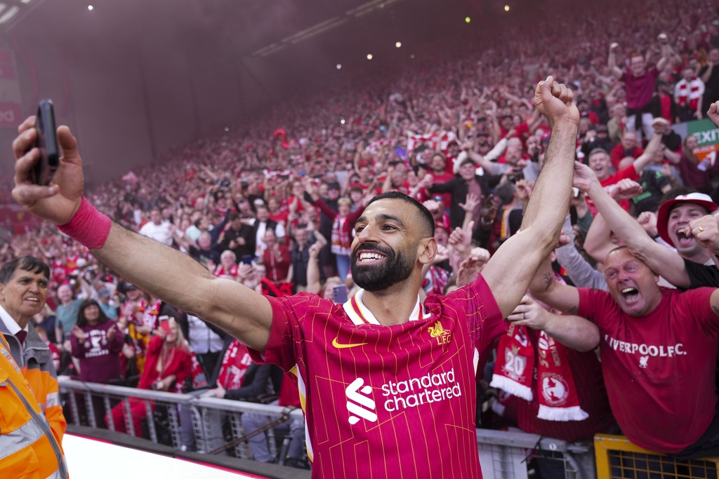 FILE - Liverpool's Mohamed Salah celebrates by taking a selfie after winning the English Premier League soccer match between Liverpool and Tottenham Hotspur and clinching the Premier League title at Anfield in Liverpool, England, Sunday, April 27, 2025. (AP Photo/Jon Super, File)