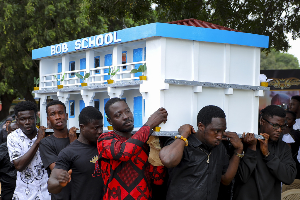 Men carry the fantasy coffin of the late Robert Nii Anang Obodai, a former school proprietor, during his funeral, in Accra, Ghana, Saturday, July 26, 2025. (AP Photo/Misper Apawu)