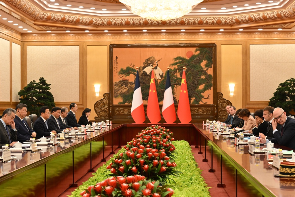 China's President Xi Jinping, second left, listens to France's President Emmanuel Macron, second right, next to China's Foreign Minister Wang Yi, left during a bilateral meeting at the Great Hall of the People in Beijing, Thursday, Dec. 4, 2025. (Adek Berry/Pool Photo via AP)