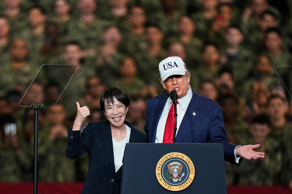 FILE - Japanese Prime Minister Sanae Takaichi gestures as U.S. President Donald Trump delivers his speech during their visit to the aircraft carrier USS George Washington at the U.S. Navy's Yokosuka base in Yokosuka, south of Tokyo, Oct. 28, 2025. (AP Photo/Eugene Hoshiko, File)