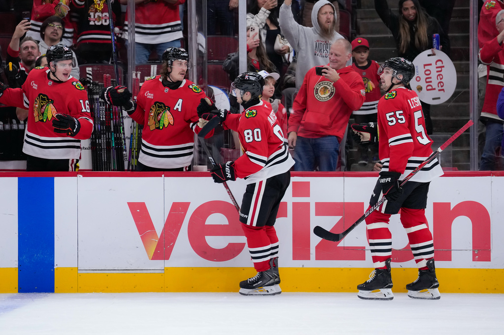 Chicago Blackhawks right wing Roman Kantserov (80) celebrates his second goal of the night with teammates during the second period of an NHL hockey game against the Pittsburgh Penguins, Tuesday, Oct. 13, 2026, in Chicago. (AP Photo/Harry Figiel)