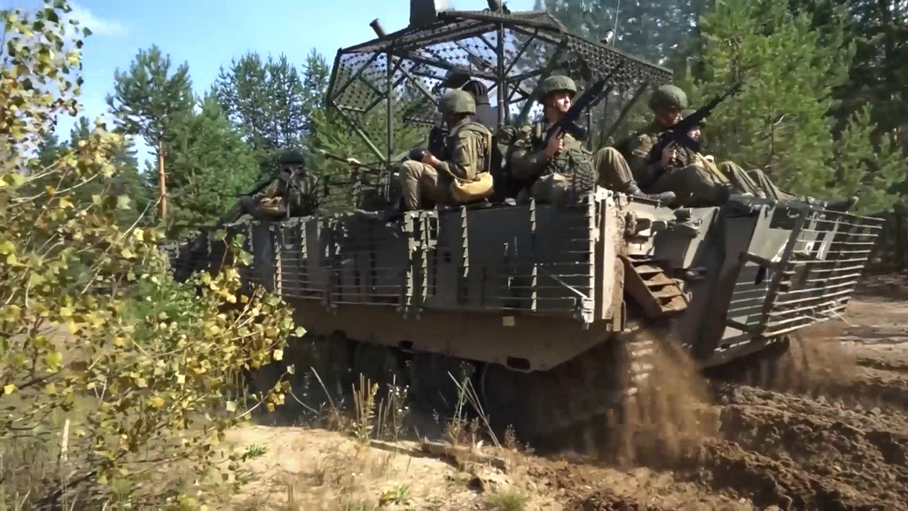 In this photo taken from video distributed by Russian Defense Ministry Press Service on Friday, Sept. 12, 2025, Armored vehicles drive during joint military drills held by Russia and Belarus. (Russian Defense Ministry Press Service via AP)