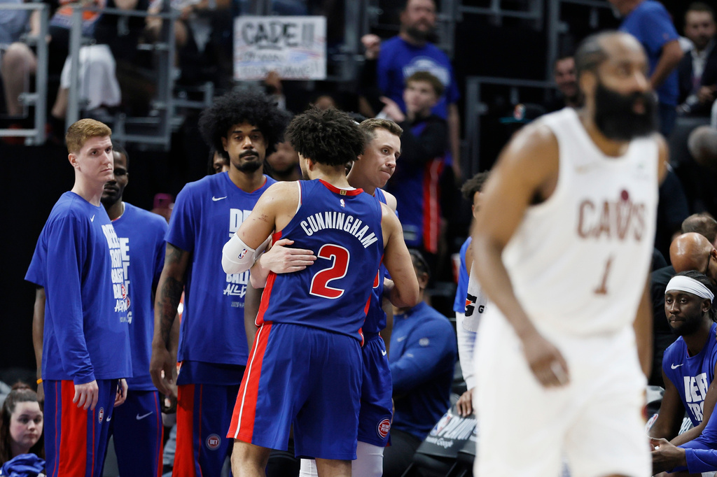 Detroit Pistons guard Cade Cunningham (2) is hugged by Duncan Robinson as Kevin Huerter, left, and Tolu Smith wait late in the fourth quarter of a loss to the Cleveland Cavaliers during Game 7 in a second-round NBA basketball playoffs series Sunday, May 17, 2026, in Detroit. (AP Photo/Duane Burleson)