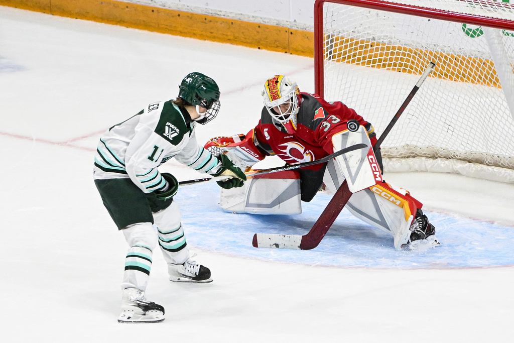 Ottawa Charge's goaltender Gwyneth Philips (33) blocks a shot by Boston Fleet's Alina Müller (11) during shootout of an PWHL hockey game in Ottawa, Saturday, Feb. 28, 2026. (Spencer Colby/The Canadian Press via AP)