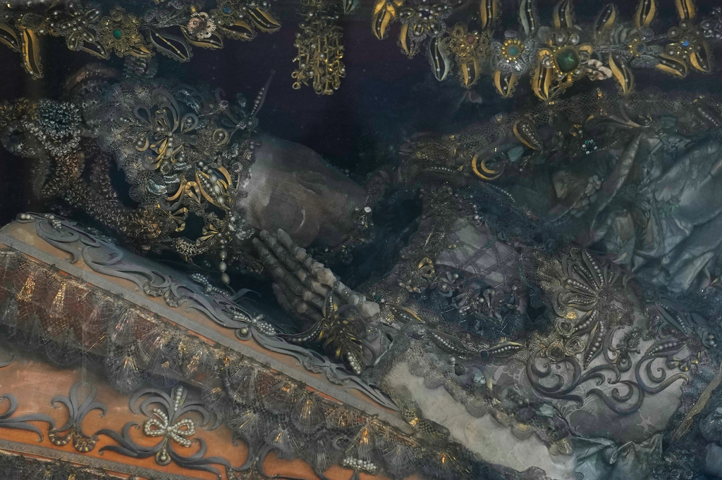 An elaborately decorated skeleton lies in the catholic monastery church of Banz in Bad Staffelstein, Germany, Saturday, May 2, 2026. (AP Photo/Matthias Schrader)