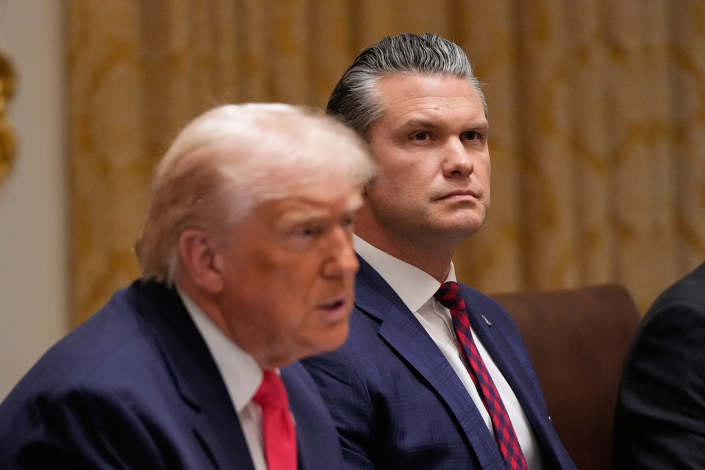 President Donald Trump speaks during a Cabinet meeting at the White House, Tuesday, Dec. 2, 2025, in Washington, as Defense Secretary Pete Hegseth looks on. (AP Photo/Julia Demaree Nikhinson)
