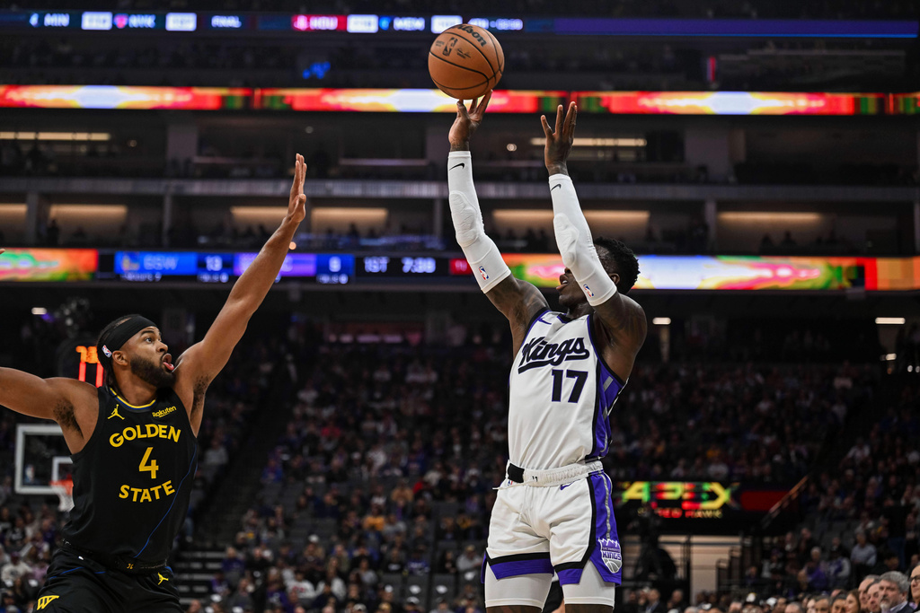 Sacramento Kings guard Dennis Schroder (17) attempts a shot over Golden State Warriors guard Moses Moody (4) during the first half of an NBA basketball game, Wednesday, Nov. 5, 2025, in Sacramento, Calif. (AP Photo/Justine Willard)