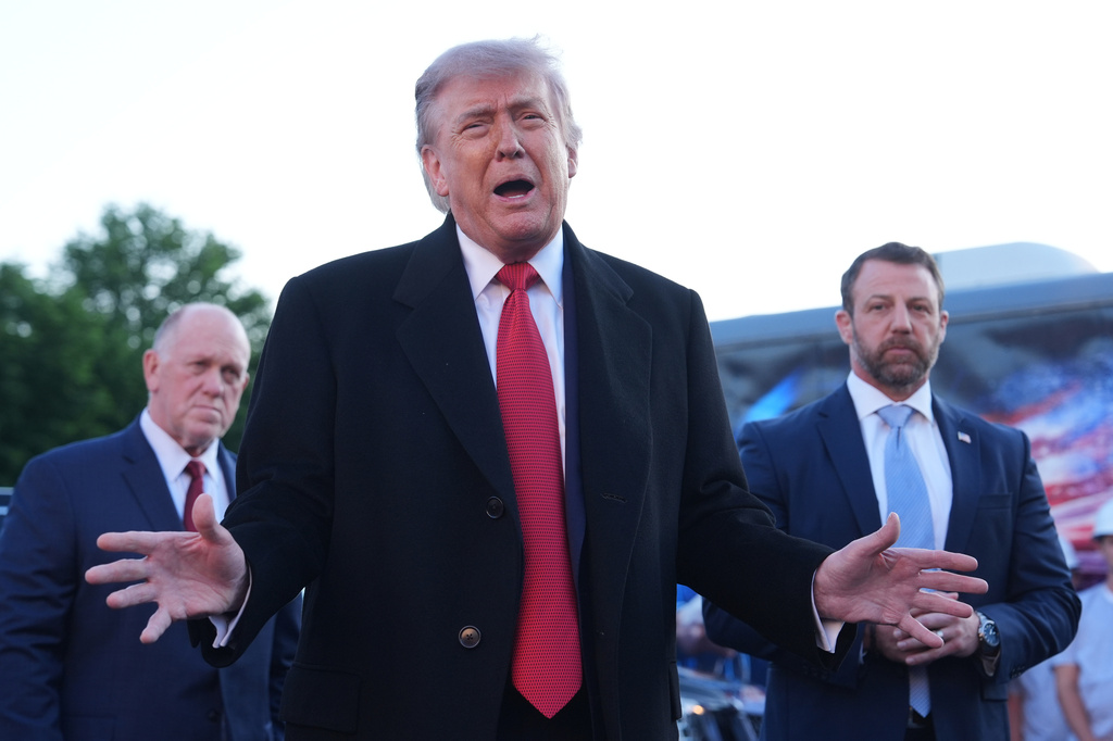 President Donald Trump speaks as he visits the Lincoln Memorial Reflecting Pool to see the new blue protective coating being applied as part of a renovation project, Thursday, May 7, 2026, in Washington, as White House boarder czar Tom Homan and Homeland Security Secretary Markwayne Mullin listen. (AP Photo/Mark Schiefelbein)