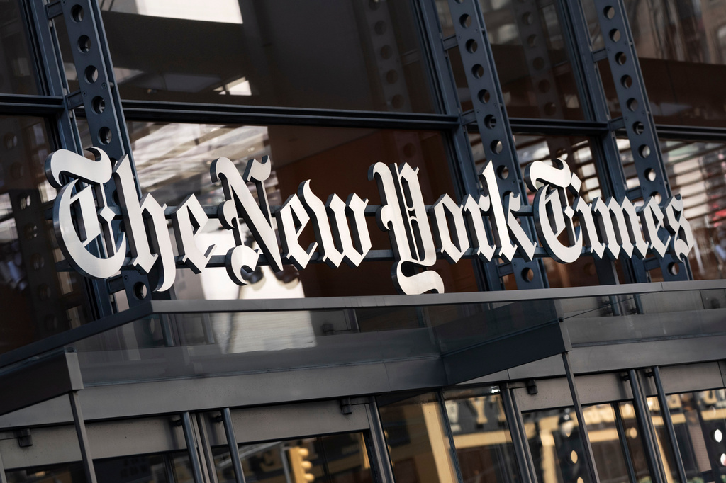 FILE - A sign for The New York Times hangs above the entrance to its building in New York, May 6, 2021. (AP Photo/Mark Lennihan, File)