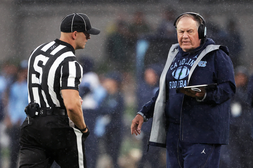 North Carolina head coach Bill Belichick, right, speaks with an official during an NCAA college football game against TCU in Dublin, Ireland, Saturday, Aug. 29, 2026. (AP Photo/Peter Morrison)