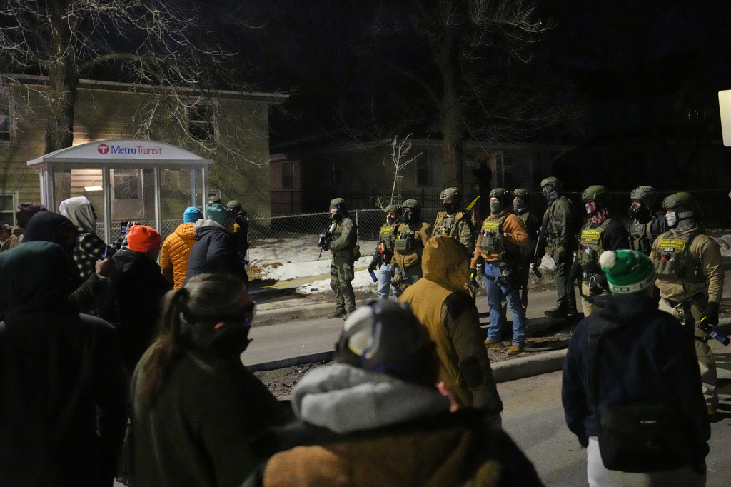 FILE - Protesters confront law enforcement at the scene of a reported shooting Wednesday, Jan. 14, 2026, in Minneapolis. (AP Photo/Abbie Parr, File)