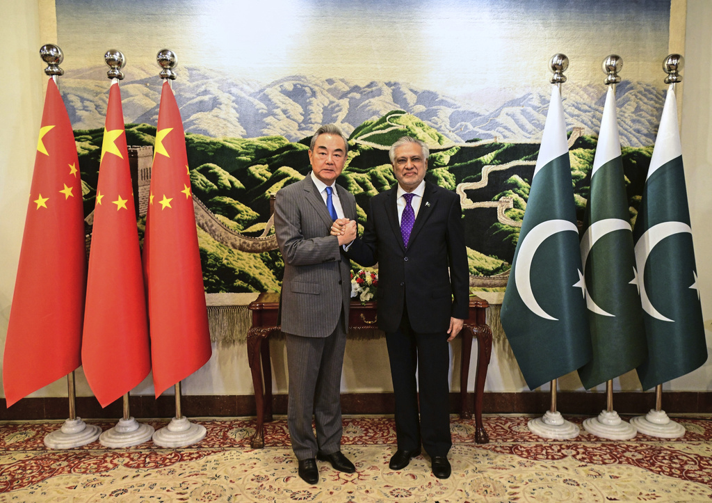 In this photo, released by the Pakistan's Ministry of Foreign Affairs, Pakistan's Deputy Prime Minister and Minister of Foreign Affairs Ishaq Dar, right, shakes hand with Chinese Foreign Minister Wang Yi, prior to their meeting in Islamabad, Pakistan, Thursday, Aug. 21, 2025. (Pakistan's Ministry of Foreign Affairs via AP)