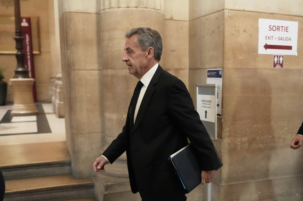 Former French President Nicolas Sarkozy arrives at the appeals courthouse in Paris, France, Tuesday, April 7, 2026, to testify in his trial appealing a conviction involving illegal campaign funds from Libya. (AP Photo/Thibault Camus)