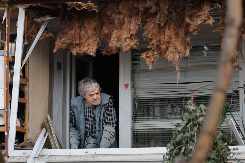 An elderly man looks out from his damaged balcony after a Russian attack in Zaporizhzhia, Ukraine, Wednesday, Jan. 28, 2026. (AP Photo/Kateryna Klochko)