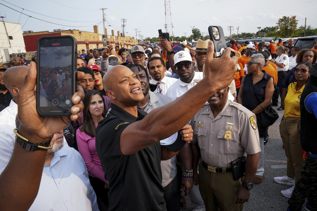 Maryland Gov. Wes Moore takes selfies with attendees ahead of a Community Walk in northwest Baltimore, Md., on Friday, Sept. 5, 2025. (Ulysses Muñoz/The Baltimore Banner via AP)